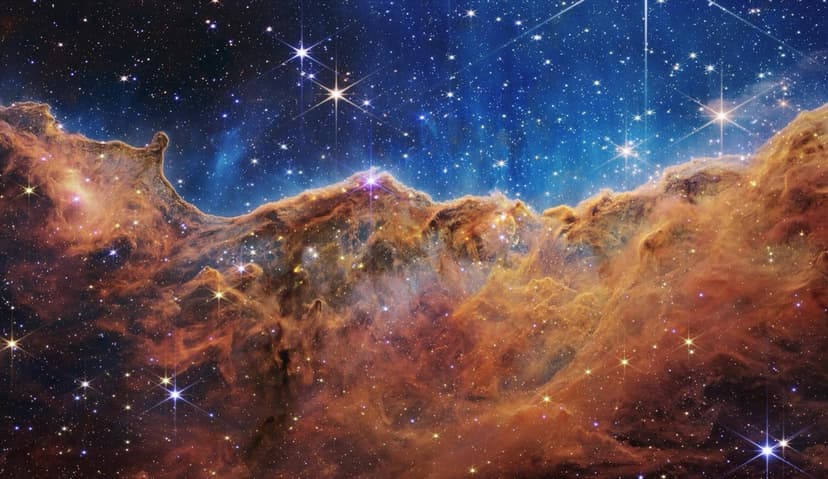 The Cosmic Cliffs of the Carina Nebula, a region of star birth, imaged by the James Webb Space Telescope.