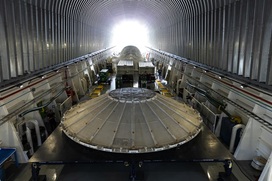 Roman Space Telescope and Artemis III SLS Core Stage Weather Cover Arrive at KSC